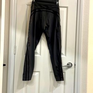 Blackish grayish leggings with stripes on the side